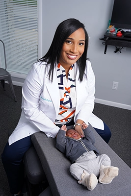 Chiropractor Munster IN Mariah Payne Adjusting Baby